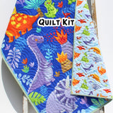 Dinosaur quilt panel with colorful prehistoric characters