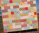 Finished quilt using Stepping Stones pattern, perfect for baby or throw size quilts, made with layer cake squares and clear instructions by Kristin Blandford Designs.