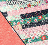 Kristin Blandford Designs Striped Out quilt pattern – colorful strip piecing design using 2.5" precut strips, shown in floral, plaid, and pastel fabrics.