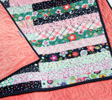 Striped Out jelly roll quilt pattern – modern lap throw with diagonal strip layout, easy quilt design by Kristin Blandford Designs.