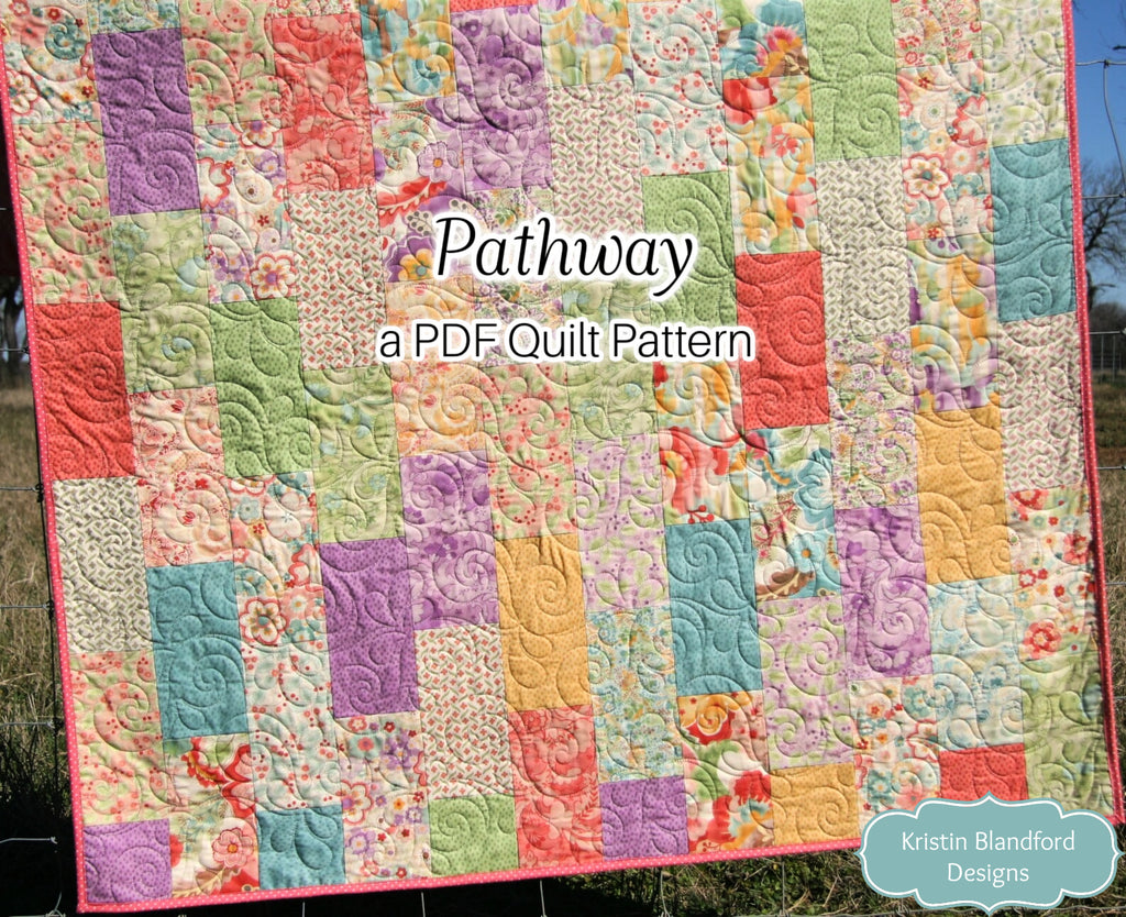 Modern layer cake quilt pattern featuring pastel floral patchwork fabrics arranged in a balanced scrappy layout with beginner-friendly quilt construction.