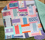 Modern Pinstripe PDF quilt pattern showcasing bold rectangular strip blocks and colorful designer fabrics in a beginner-friendly quilt layout perfect for baby quilts and throw quilts.