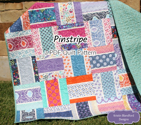 Modern Pinstripe PDF quilt pattern showcasing bold rectangular strip blocks and colorful designer fabrics in a beginner-friendly quilt layout perfect for baby quilts and throw quilts.