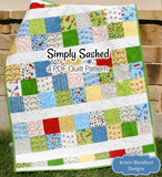 Charm pack friendly baby quilt pattern featuring colorful patchwork fabrics and novelty transportation prints in a beginner-friendly modern quilt design perfect for boys nursery décor and baby shower gifts.