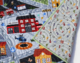 Nursery playmat blanket with town buildings, vehicles, and roads for imaginative baby or toddler playtime.