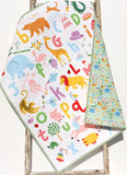 Educational ABC quilt kit for babies, bright block letters, crayon motif, ideal for early learning décor.