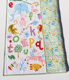 Educational alphabet baby quilt with embroidered name, handmade blanket featuring letters and animals for baby shower gifts.
