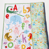 Handmade ABC quilt with embroidered name, colorful alphabet and animal prints, perfect for newborn or toddler gift.