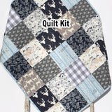 Navy and gray woodland quilt kit with rustic deer, owls, feathers, and teepee fabrics for baby or throw patchwork quilt.