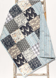 Forest animal baby quilt kit featuring navy and gray prints, perfect for beginner sewing and nursery décor.