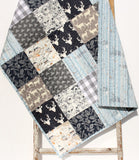 DIY baby quilt sewing kit with navy woodland fabrics, beginner-friendly patchwork, and rustic forest animal designs.