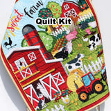 Farmyard panel quilt kit with red barn, tractors, and friendly farm animals, including binding and backing for baby gift sewing.