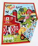 Farmyard theme baby quilt with red barn, tractor, cows and pig prints combined with personalized embroidery detail.