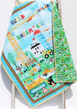Baby/toddler blanket kit featuring construction vehicles panel and choice of cotton or minky backing, ready-to-sew.