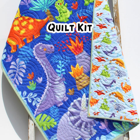 Dinosaur quilt panel with colorful prehistoric characters