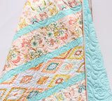 Baby bedding quilt featuring butterflies and florals for a sweet girl nursery theme