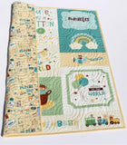 Personalized nursery quilt designed to be treasured as an heirloom baby gift