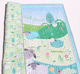 Nursery quilt kit with lambs, rolling hills, and soft green and blue tones
