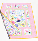 Handmade baby quilt created using a pink butterfly fabric panel