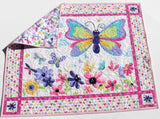 Colorful butterfly panel quilt with floral accents for a baby activity mat