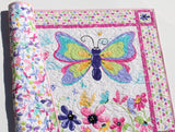 Baby play mat quilt featuring butterflies flowers and colorful fabric borders