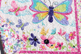 Baby floor quilt made from a butterfly panel quilt kit with bright floral design