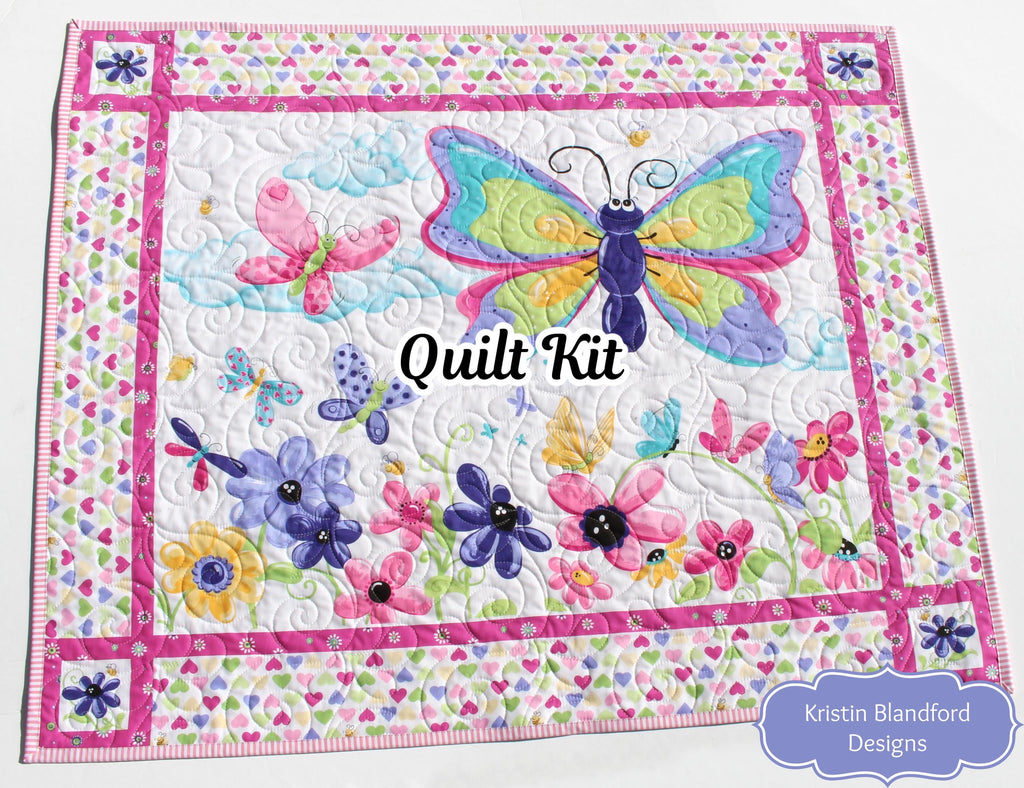 Butterfly play mat quilt kit featuring a large colorful butterfly fabric panel and floral borders