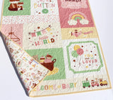 Personalized baby quilt with custom embroidered name in pink and green
