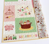 Crib quilt blanket with pink and green color palette
