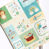 Handmade baby boy quilt featuring a playful nursery panel with animals and soft blue and green tones