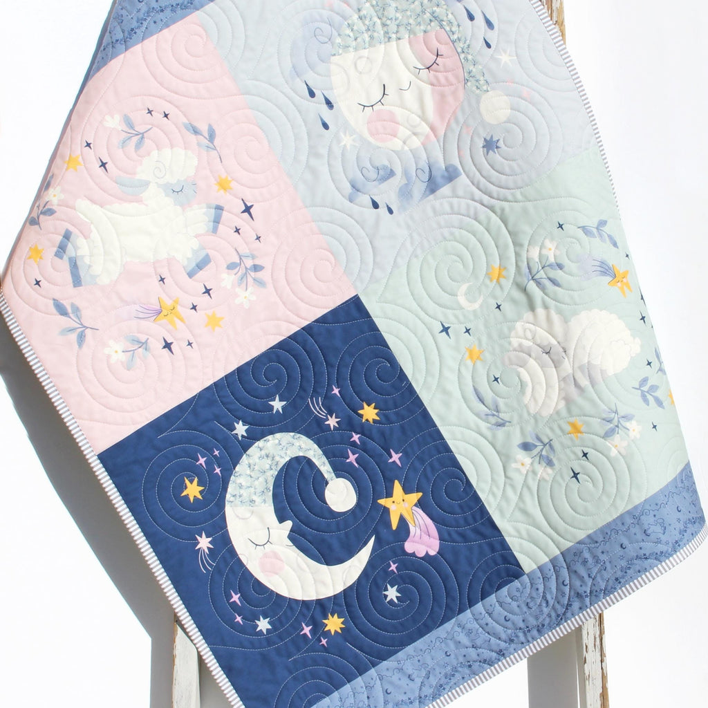Twinkle Little Star baby crib quilt with moon and cloud design for a calming nursery