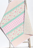 cottage style quilt kit with pastel floral cotton fabrics arranged in stripes