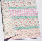 quilt kit with floral stripe design and coordinating gingham center panel